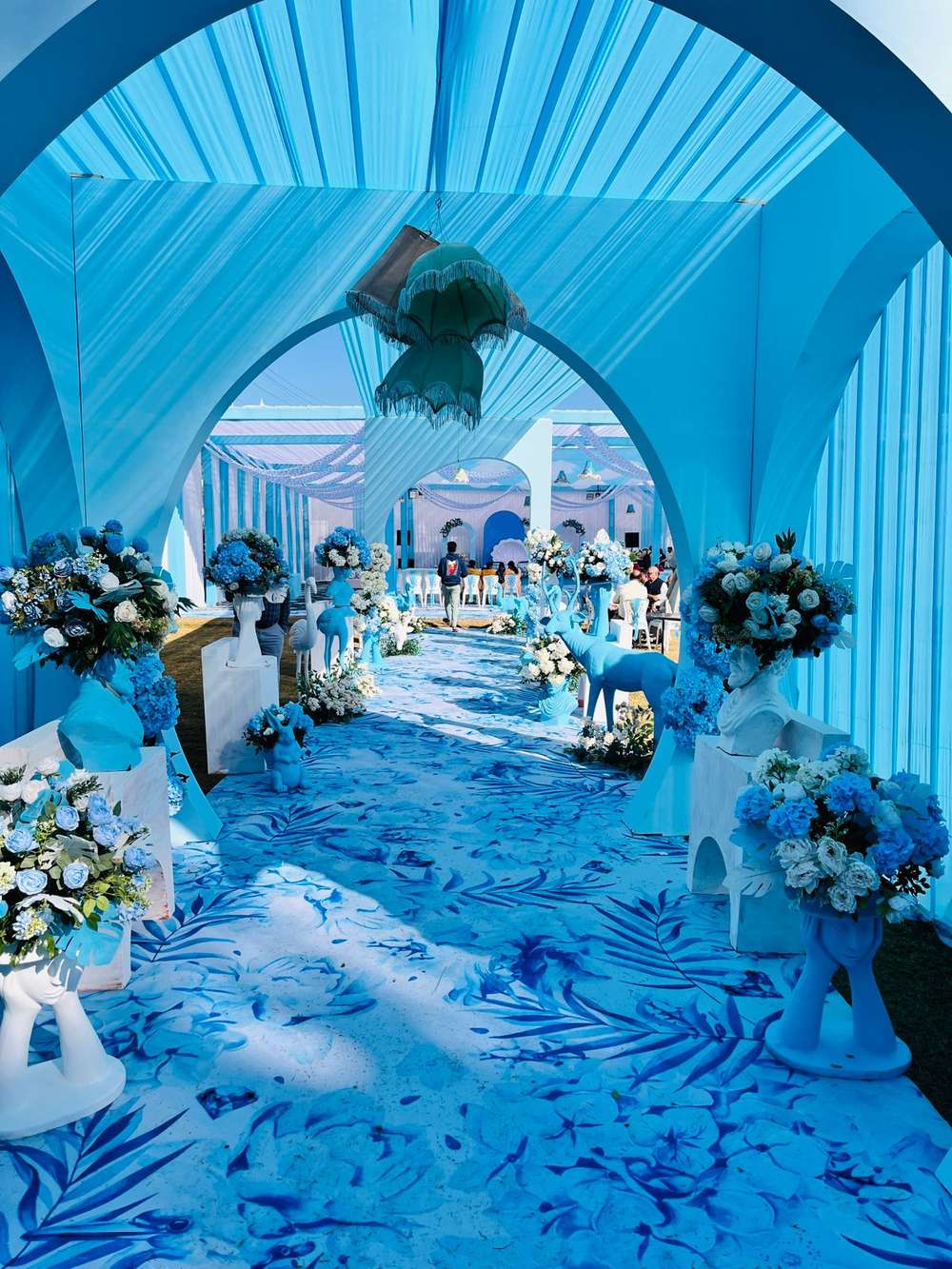 Blue themed wedding venue viewed through an arch
