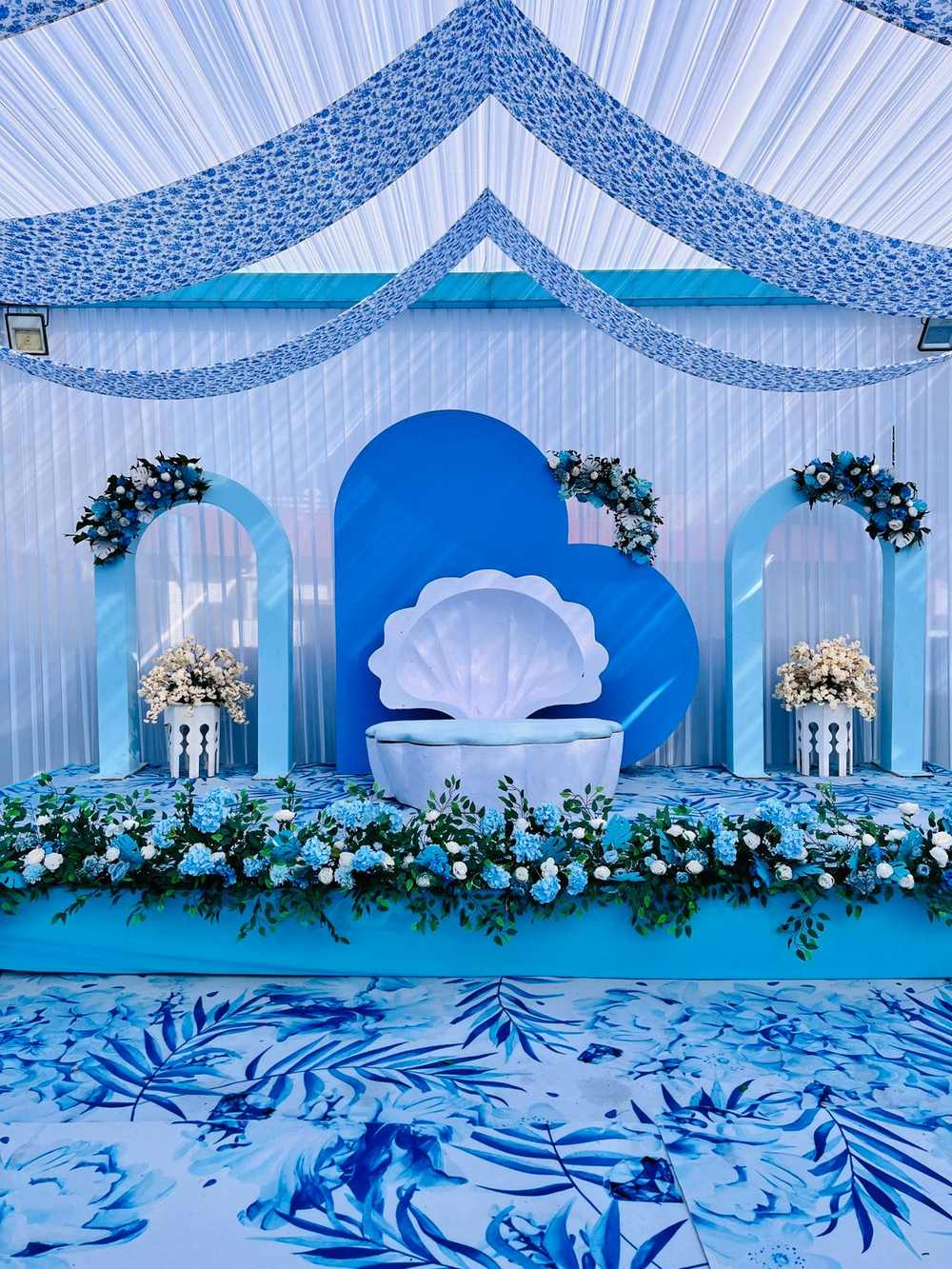Blue floral wedding stage with patterned flooring